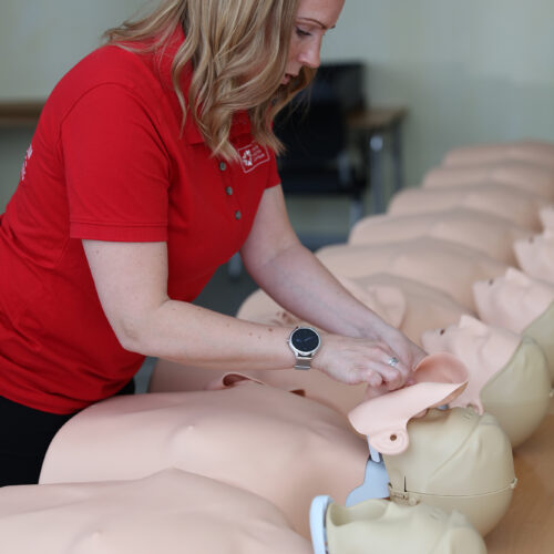 Kvinna byter ansikten på HLR-dockor. Auktorsierade återförsäljare av Laerdal.